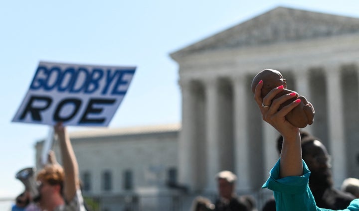 Anti-abortion protesters march in front of the Supreme Court building on June 13, 2022, in Washington, D.C.