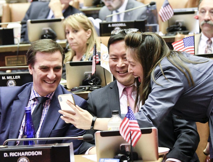 Niou chats with Assemblyman Ron Kim (D), center, and state Senate Deputy Majority Leader Michael Gianaris (D), left. She is part of a new crop of progressive New York lawmakers.