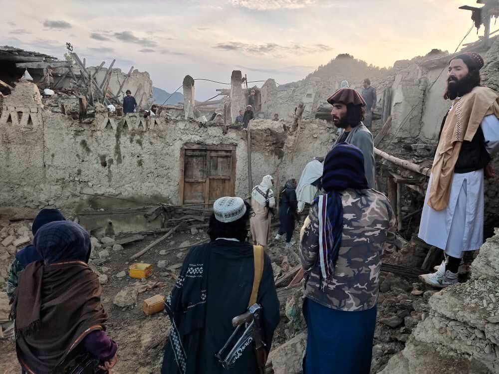 In this photo released by a set-run news agency Bakhtar, Afghans look at destruction caused by an earthquake in the province of Paktika, eastern Afghanistan, Wednesday, June 22, 2022. (Bakhtar News Agency via AP)