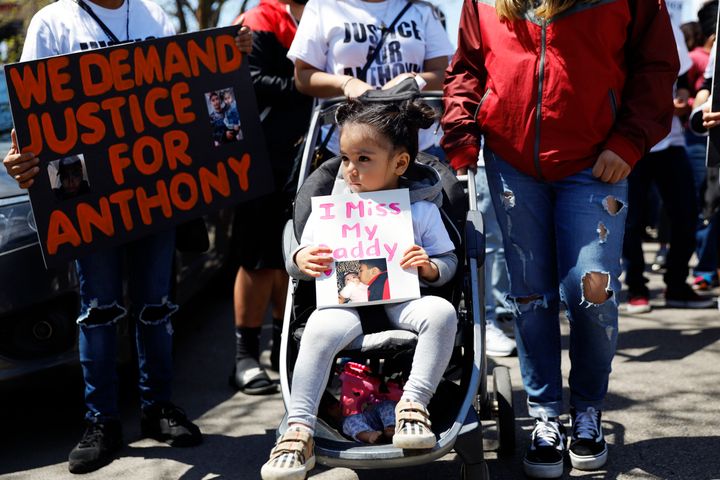 Ailani Alvarez, 2, daughter of Anthony Alvarez who was shot by the police, holds a sign reading "I miss my daddy" during a protest on May 1, 2021 in Chicago.