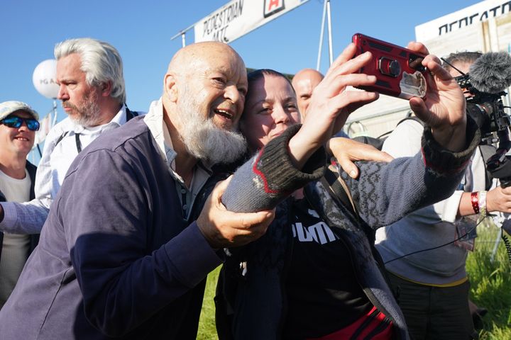 Michael Eavis poses for a selfie with Glastonbury attendees