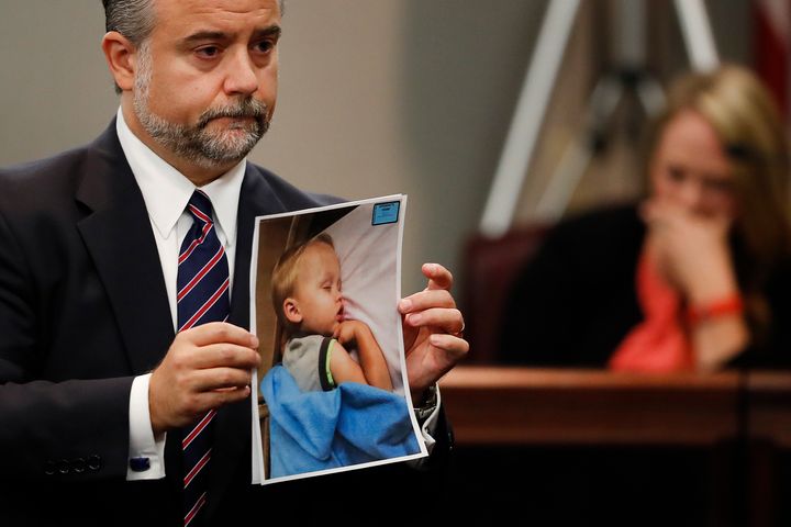 Harris' defence  lawyer  Maddox Kilgore holds a photograph  of Cooper Harris during the execution  trial. 