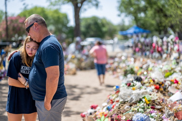 Olivia Luna, 15, is comforted at a memorial in front of Robb Elementary School on June 17 in Uvalde, Texas.