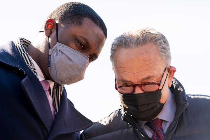 Jones confers with Senate Majority Leader Chuck Schumer (D-N.Y.) at a student debt cancellation event. Jones is closer to Democratic leaders than some other progressives.
