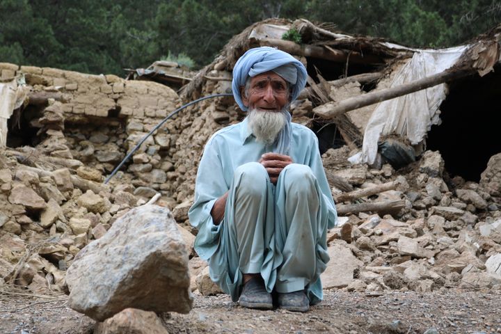 An Afghan man sits near his house that was destroyed in an earthquake in the Spera District of the southwestern part of Khost Province, Afghanistan on Wednesday.