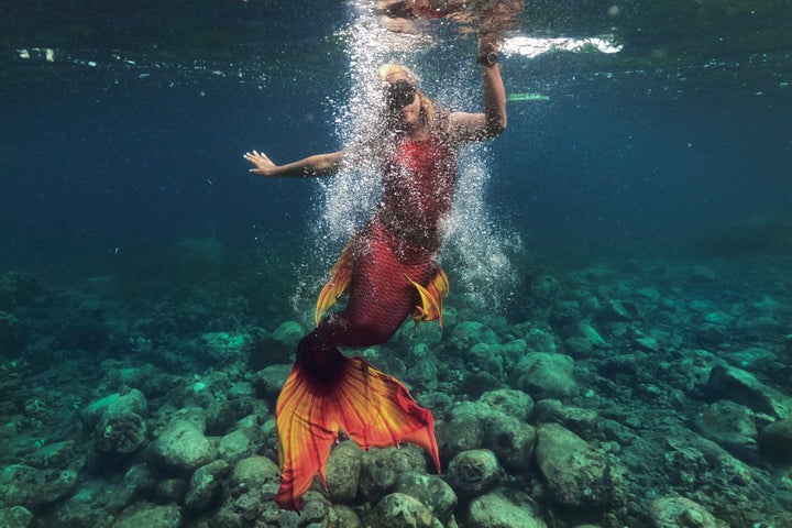 Queen Pangke Tabora swims in her mermaid suit while she conducts a mermaiding class in front of the Ocean Camp in Mabini, Batangas province, Philippines on Sunday, May 22, 2022. “The world outside is really noisy and you will find peace under water. … It’s a good skill in the real world, especially during the pandemic.” (AP Photo/Aaron Favila)