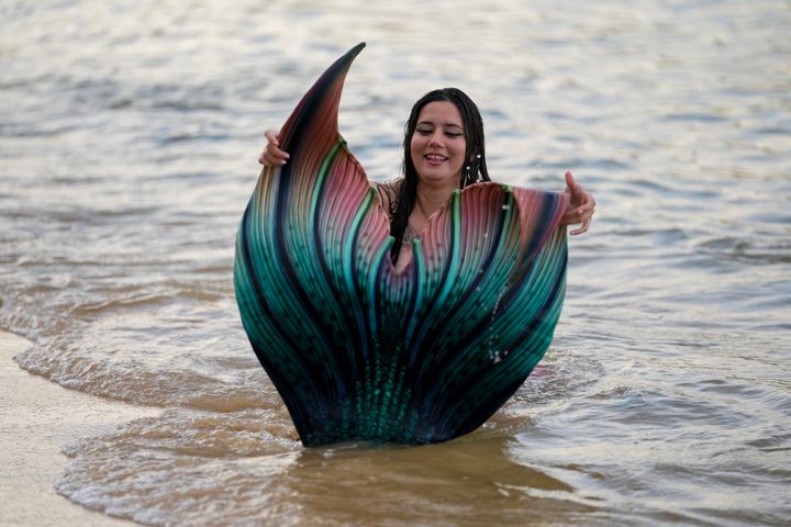 Lauren Metzler, founder of Sydney Mermaids, prepares for a swim at Manly Cove Beach in Sydney, Australia, Thursday, May 26, 2022. Metzler received her advanced mermaid certification this month with a goal of teaching rookie merfolk how to avoid sinking to the seabed. (AP Photo/Mark Baker)