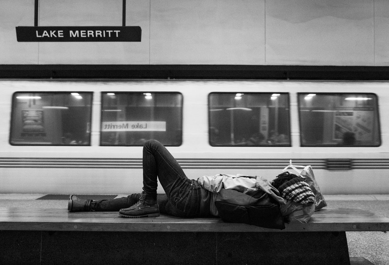 A homeless woman sleeps on a bench at a BART station in Oakland, California. Telling the story of contemporary violence against Black women and girls means taking stock of the ways we routinely harm those on the margins.