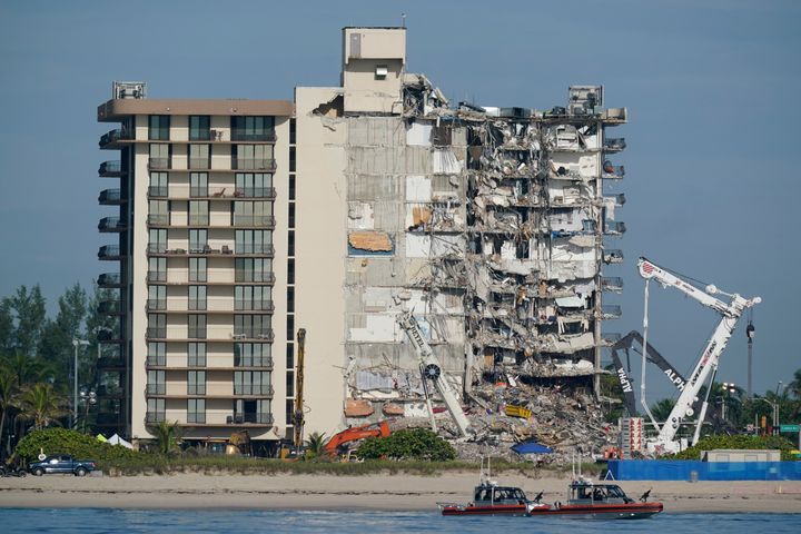 In this Thursday, July 1, 2021, file photo, U.S. Coast Guard boats patrol in front of the partially collapsed Champlain Towers South condo building in Surfside, Florida. (AP Photo/Mark Humphrey, File)