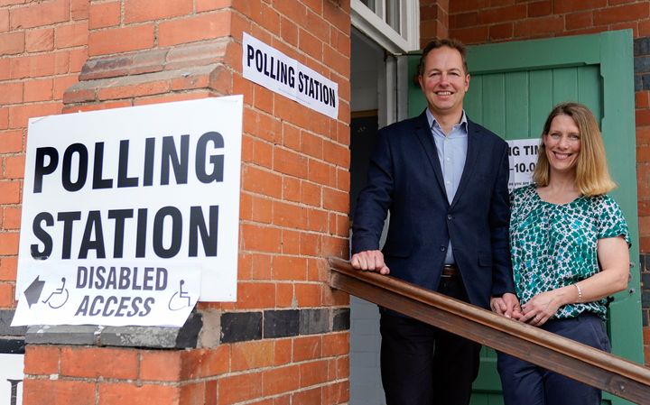 The Liberal Democrats' by-election candidate Richard Foord (left) poses for a photograph with his wife Kate after they cast their votes at the Uffculme Village Hall in Uffculme.