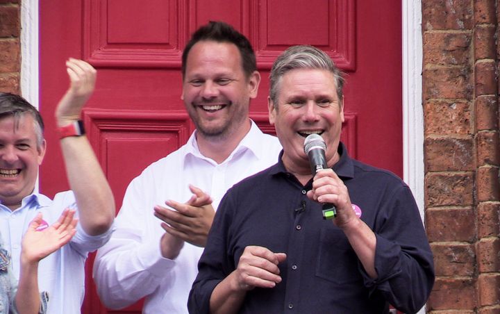 Winning Labour candidate Simon Lightwood stands behind Keir Starmer during the Wakefield by-election campaign.
