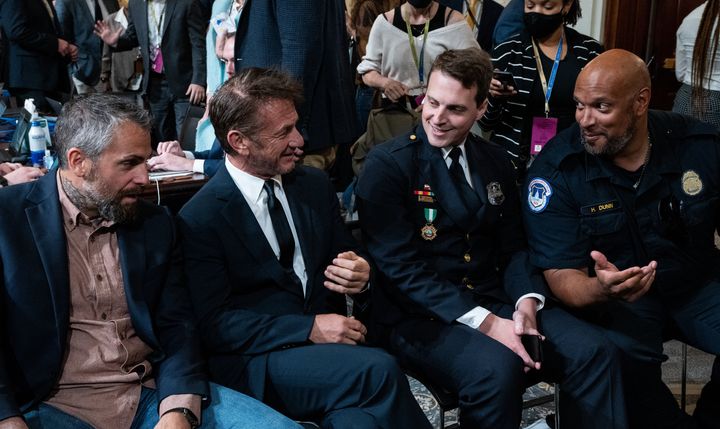 From left, retired D.C. Metropolitan Police Officer Michael Fanone, actor Sean Penn, D.C. Metropolitan Police Officer Daniel Hodge and U.S. Capitol Police Officer Harry Dunn talk during the hearing held by the House select committee investigating the Jan. 6, 2021 attack on the U.S. Capitol.