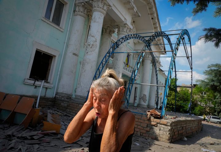 A woman covers her ears reacting to a Russian air raid in Lysychansk, Luhansk region, Ukraine, on June 16, 2022.