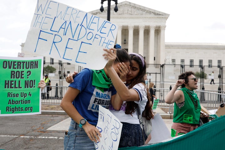 Abortion rights activists react to the Dobbs v. Jackson Women's Health Organization ruling in front of the Supreme Court on June 24, 2022, in Washington, D.C.