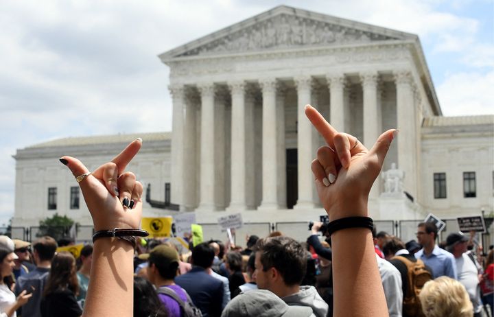 Abortion rights activists react to the seismic court decision overturning Roe v. Wade outside the Supreme Court in Washington, D.C., on June 24.
