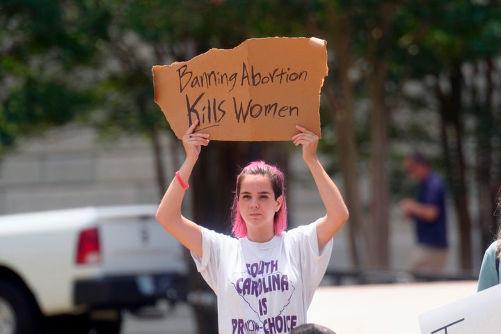 An abortions rights supporter protests outside the South Carolina statehouse Friday. A South Carolina law prohibiting abortion once a fetal heartbeat is detected, at about six weeks, had been on hold pending the Supreme Court's ruling.