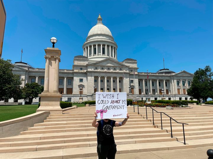 A demonstrator holds a sign outside the Arkansas state Capitol in Little Rock.