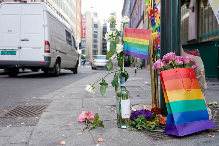 Flowers are left at the scene of a shooting in central Oslo on June 25, 2022.