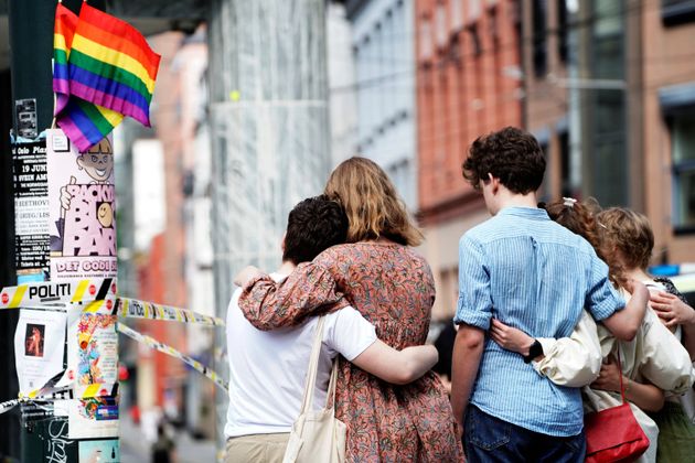 People embrace near the police line following a shooting at the London Pub, a popular gay bar and nightclub, in central Oslo, Norway June 25, 2022. Terje Pedersen/NTB/via REUTERS ATTENTION EDITORS - THIS IMAGE WAS PROVIDED BY A THIRD PARTY. NORWAY OUT. NO COMMERCIAL OR EDITORIAL SALES IN NORWAY.