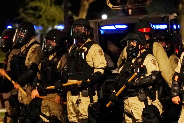 Police in riot gear surround the Arizona Capitol after protesters reached the front of the state Senate building in reaction to the Supreme Court decision to overturn the landmark Roe v. Wade abortion decision on Friday.