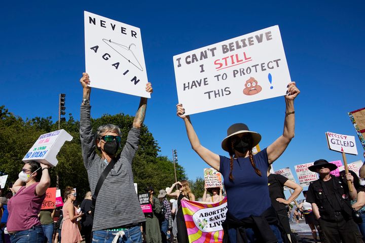 Protesters hold signs in Portland, Ore., about the Supreme Court's decision overruling Roe v. Wade, June 24, 2022. (AP Photo/Craig Mitchelldyer, File)