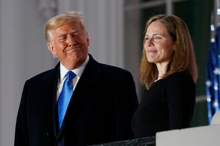 Then-President Donald Trump and Amy Coney Barrett stand on the Blue Room balcony after Supreme Court Justice Clarence Thomas swore her the Constitutional oath on the southern lawn of the White House White House in Washington, October 26, 2020. (AP Photo / Patrick Semansky , file)
