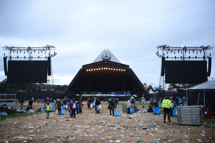 Festival-goers help in cleaning up the venue at the end of Glastonbury, on June 27, 2022. 