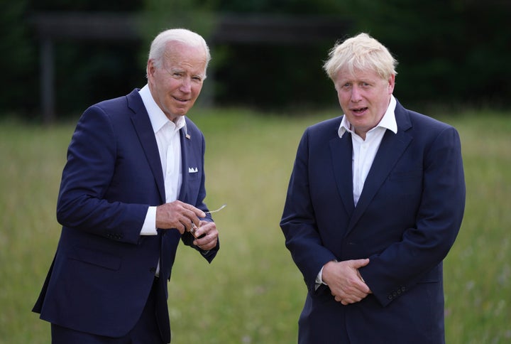 U.S. President Joe Biden, left, speaks with British Prime Minister Boris Johnson during the official G7 group photo at Castle Elmau in Kruen, near Garmisch-Partenkirchen, Germany, on June 26, 2022.