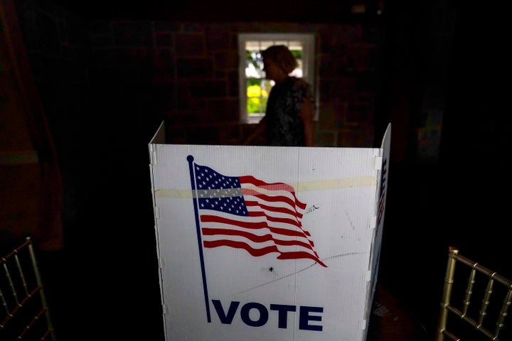 A person waits in line to vote in the Georgia's primary election on May 24, 2022, in Atlanta. More than 1 million voters across 43 states have switched to the Republican Party over the last year, according to voter registration data analyzed by The Associated Press. (AP Photo/Brynn Anderson, File)