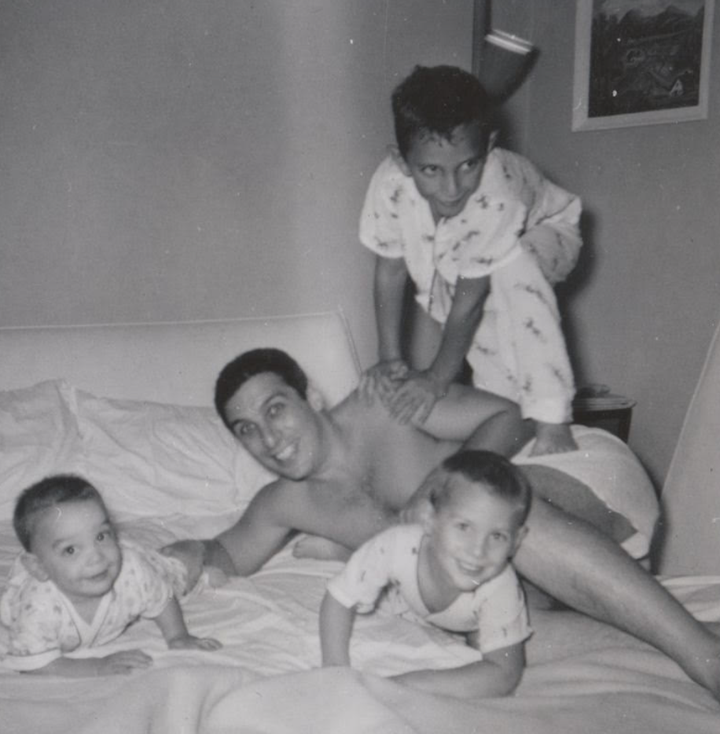 A 1959 photo shows Eugene Glick with his sons, Steve (left), Daniel (center) and Bob (on top of Eugene), who died in 2001.