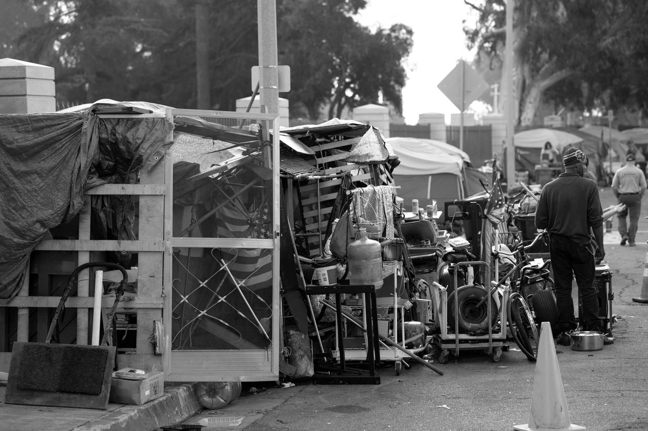 Los Angeles, CA - March 10:Los Angeles county sheriff deputies stand by as crews begin removing a homeless encampment in front of the Veterans Administration in Westwood, California, on Nov. 1, 2021. About 50 homeless vets who had been living on the sidewalk in front of the facility were being relocated.