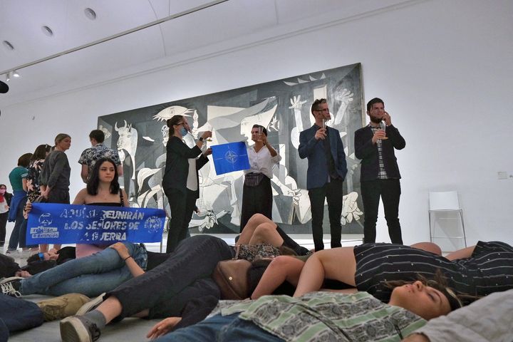 Extinction Rebellion activists protest in front of Pablo Picasso's 'Guernica' painting at Reina Sofia museum against a NATO summit in Madrid, Spain, June 27, 2022. Extinction Rebellion/Aurele Castellane/Handout via REUTERS