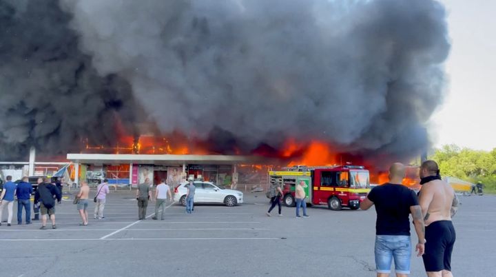 Smoke rises from a shopping mall hit by a Russian missile strike.