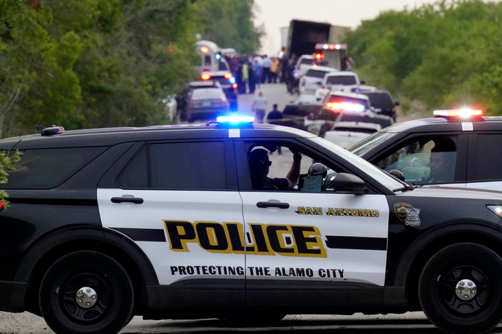 Police block the scene where a tractor-trailer that contained multiple dead bodies was discovered Monday in an industrial area on the southern outskirts of San Antonio.