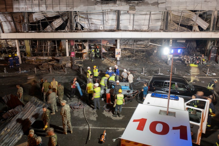 Ukrainian State Emergency Service firefighters work to extinguish a fire at a shopping center burned after a rocket attack in Kremenchuk, Ukraine, on June 27, 2022.