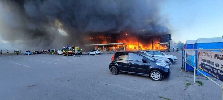 Ukrainian firefighters are seen trying to put the fire out a burning shopping mall after a Russian attack in Kremenchuk, Poltava region, on June 27.