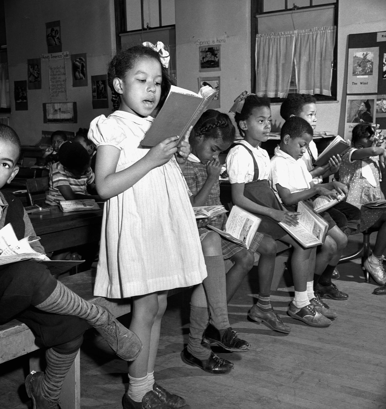 Young African American children attending a reading lesson in a segregated elementary school, Washington, D.C., March 1942.