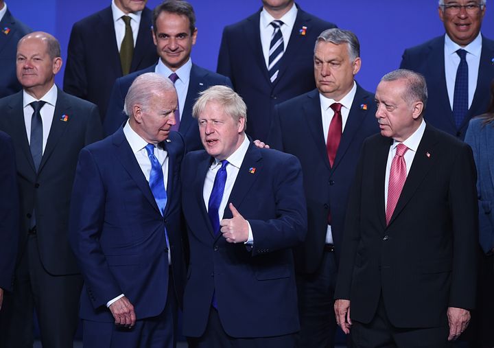 MADRID, SPAIN - JUNE 29: US President Joe Biden (L) chats with British Prime Minister Boris Johnson and Turkish President Recep Tayyip Erdogan (R) during a group photo at the NATO Summit on June 29, 2022 in Madrid, Spain. During the summit in Madrid, NATO leaders will make the historic decision whether to increase the number of high-readiness troops above 300,000 to face the Russian threat. (Photo by Denis Doyle/Getty Images)