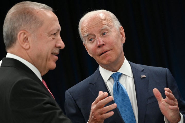 Turkey's President Recep Tayyip Erdogan speaks with U.S. President Joe Biden at the start of the first plenary session of the NATO summit in Madrid, Spain on June 29, 2022.