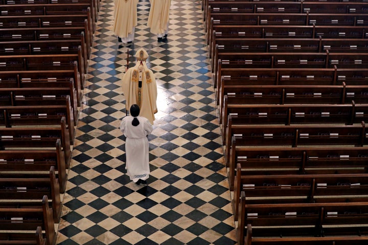 Archbishop Gregory Aymond conducts the procession to lead a live streamed Easter Mass in St. Louis Cathedral in New Orleans, on April 12, 2020. The FBI has opened a widening investigation into Roman Catholic sex abuse in New Orleans, looking specifically at whether priests took children across state lines to molest them. 