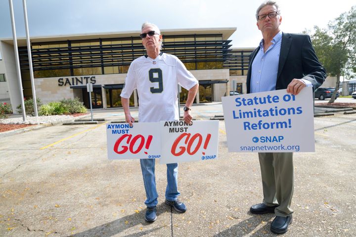 Members of SNAP, the Survivors Network of those Abused by Priests, including Richard Windmann, left, and John Gianoli, right, hold signs during a conference in front of the New Orleans Saints training facility in Metairie, La., Wednesday Jan. 29, 2020.