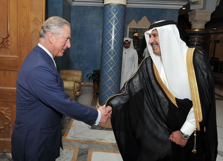 Prince Charles shakes hands with former Qatari prime minister Sheikh Hamad Bin Jassim, at his residence outside Doha, Qatar.