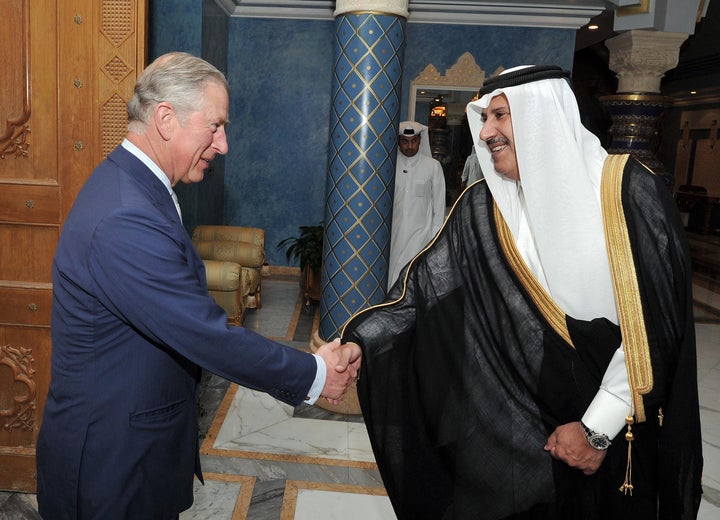 Prince Charles shakes hands with former Qatari prime minister Sheikh Hamad Bin Jassim, at his residence outside Doha, Qatar.