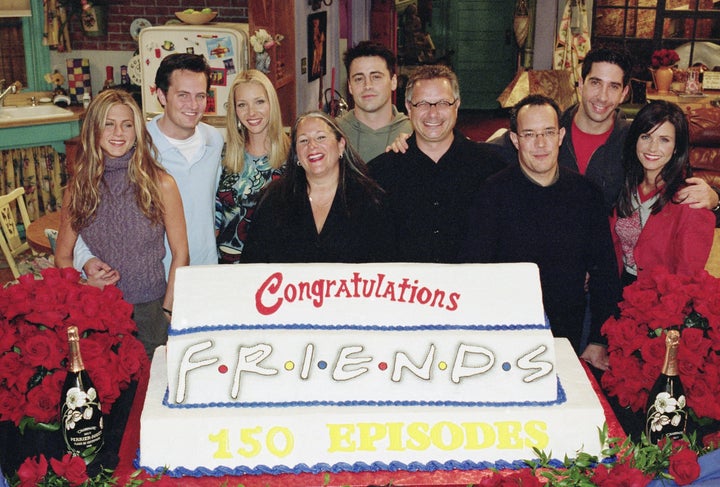 Marta Kauffman (front row centre), Kevin Bright, David Crane and the Friends cast celebrate the show's 150th episode.