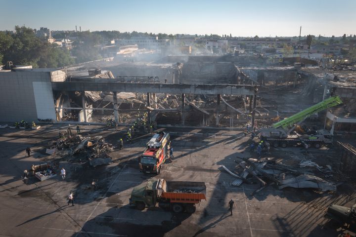 Ukrainian State Emergency Service firefighters work to take away debris at a shopping center burned after a rocket attack in Kremenchuk, Ukraine, on June 28, 2022.