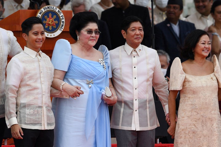 Former first lady Imelda Marcos (second from left) holds hands with her son, the new Philippine President Ferdinand Marcos Jr. (second from right), as they stand with family members after he took his oath of office on June 30, 2022.