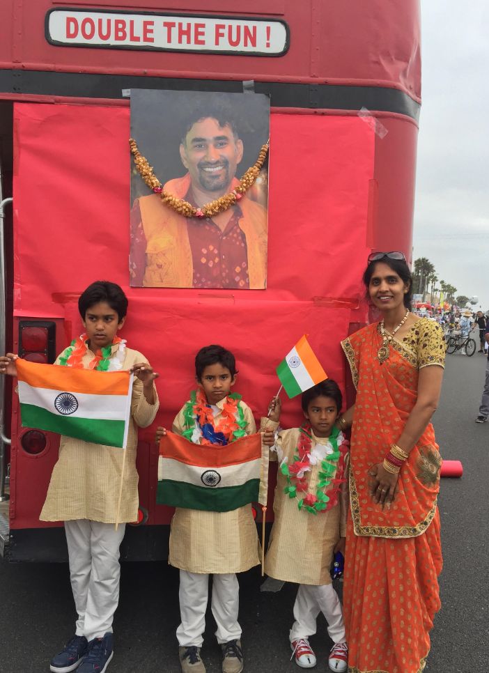 The back of the float, featuring a garlanded photo of the author's brother, Hitesh S. Barot, and his wife and three sons standing in front of it.