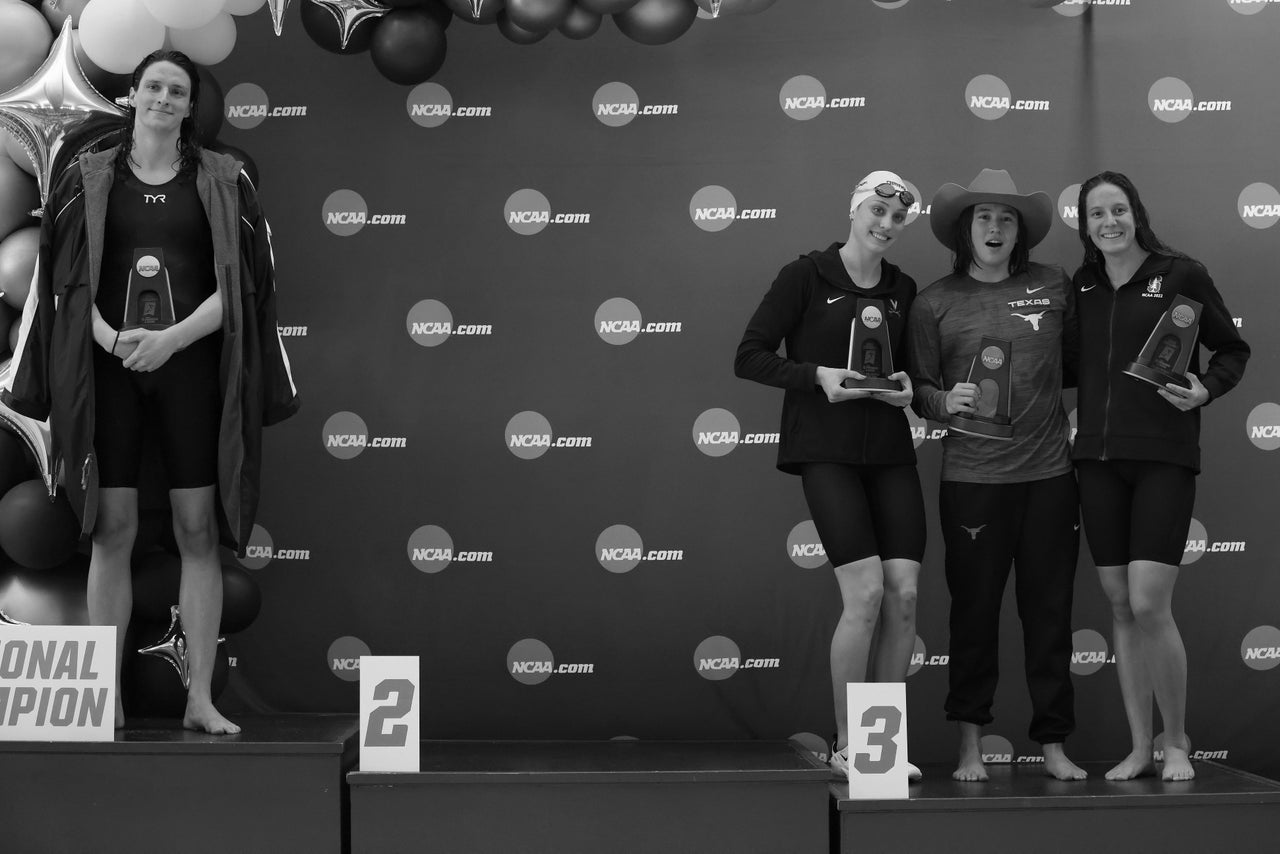 Lia Thomas, left, of the University of Pennsylvania stands on the podium after winning the 500-yard freestyle as other medalists Emma Weyant, Erica Sullivan and Brooke Forde pose for a photo, March 17, 2022, in Atlanta.