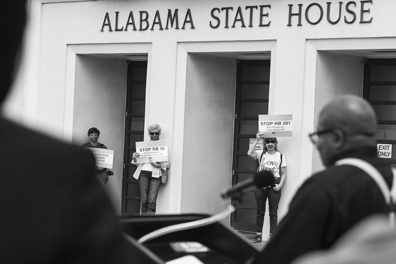 Opponents of several bills targeting transgender youth attend a rally at the Alabama State House on March 30, 2021, in Montgomery.