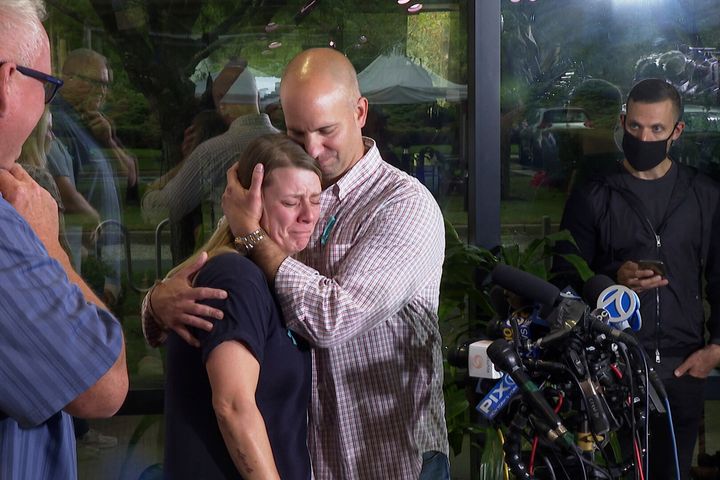 A tearful Nichole Schmidt, the mother of Gabby Petito, is comforted by her husband, Jim Schmidt, during a news conference last year.